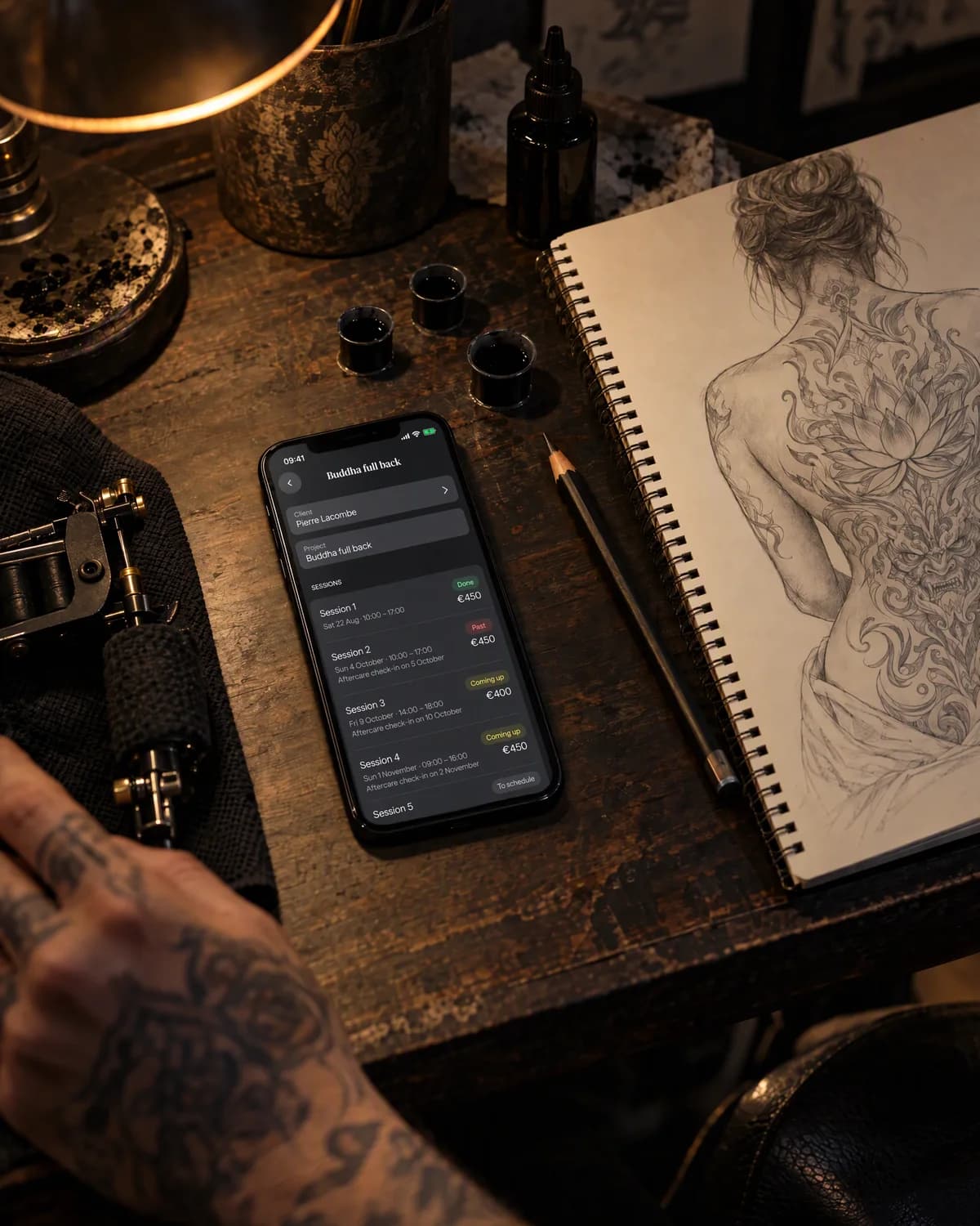 Staged photo: a multi-session project in needlz, on an iPhone next to a sketch