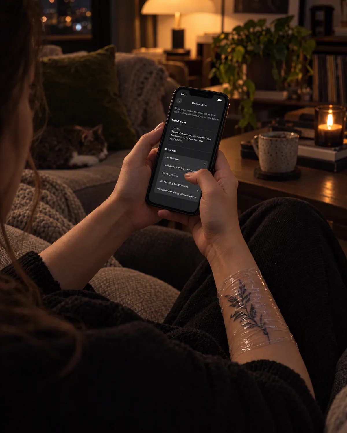Staged photo: a client fills in the consent form on their iPhone at home